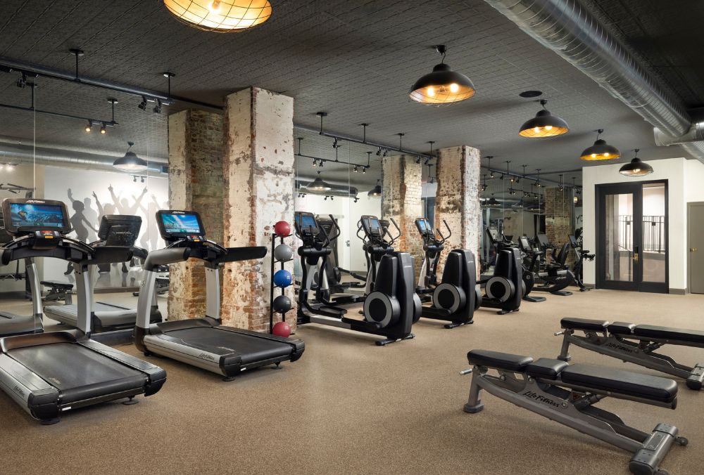 Fitness center with treadmills, ellipticals, weight machines, and exercise balls