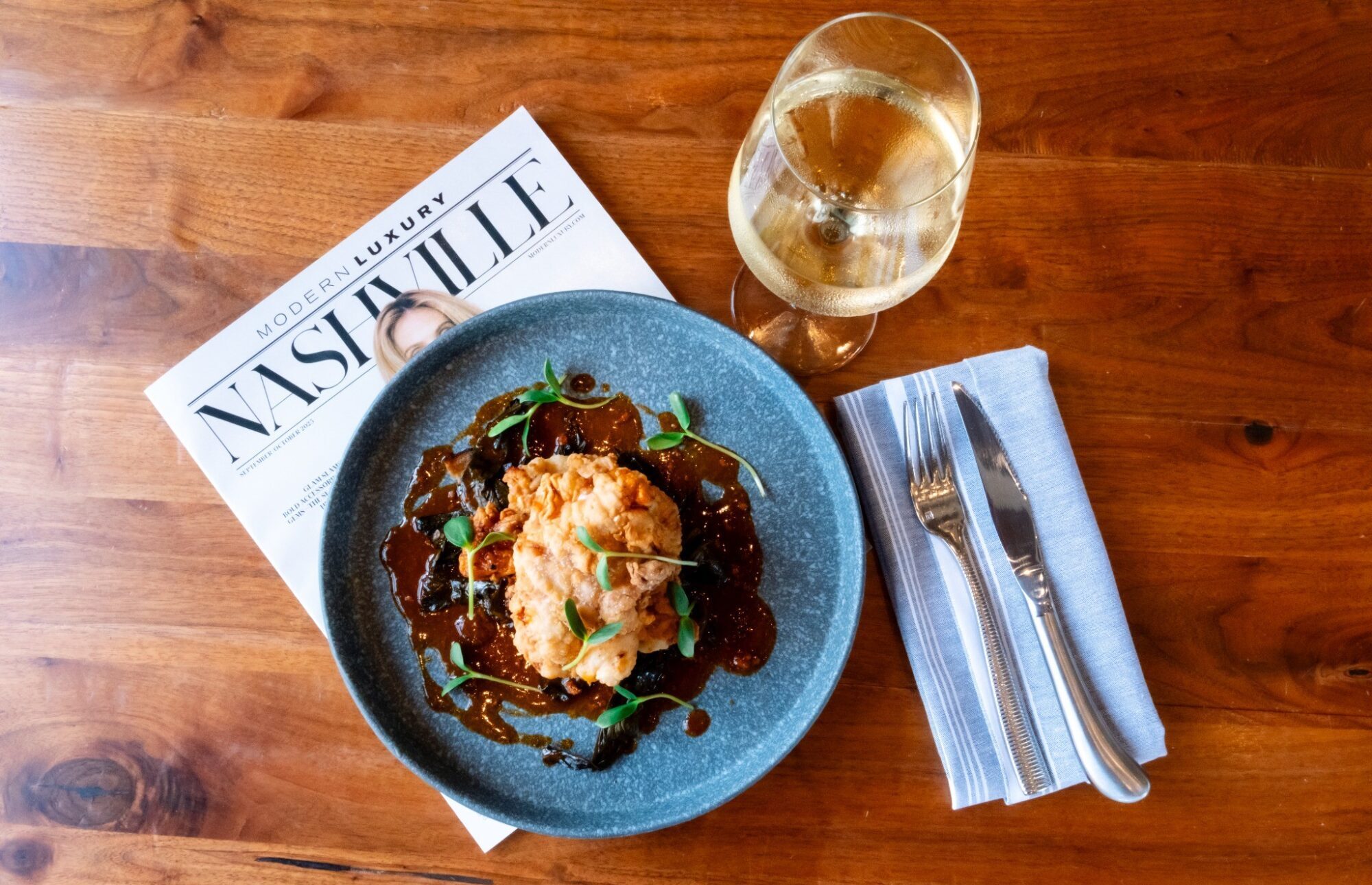 Stationairy Nashville fried chicken dish with wine and table setting