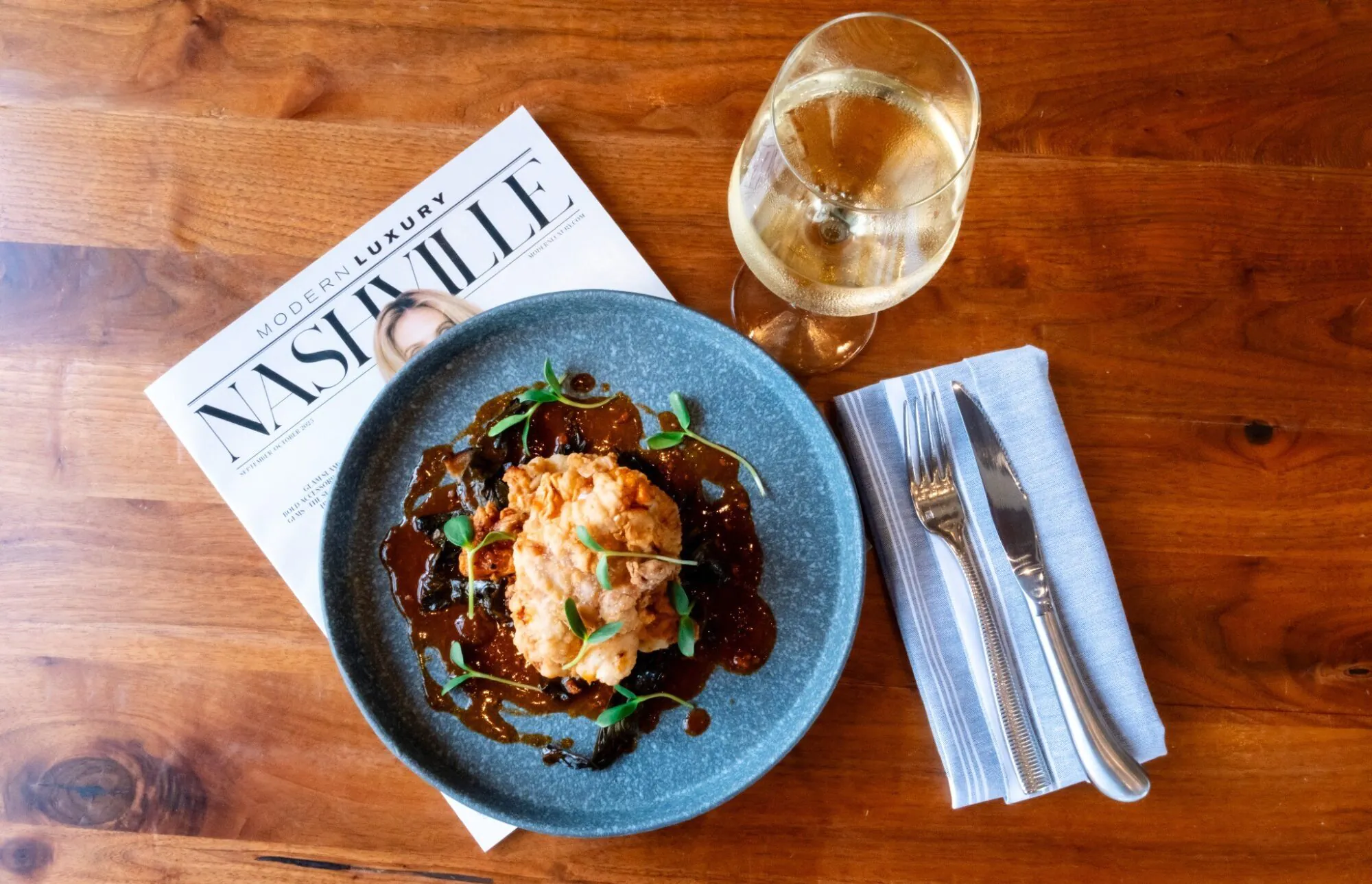 Stationairy Nashville fried chicken dish with wine and table setting