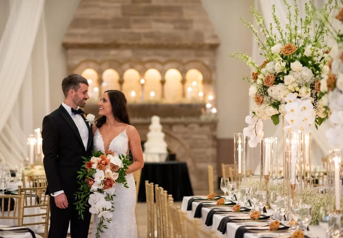 Bride and groom smiling at wedding reception