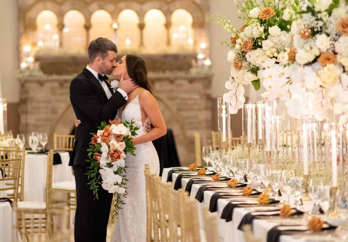 Bride and groom kissing at wedding reception